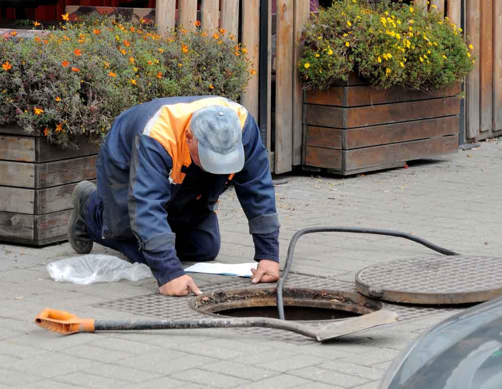 a municipal sewer / worker inspecting municipal sewer