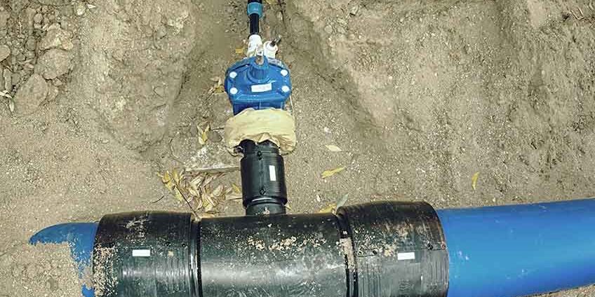 300mm main HDPE pipe of potable water supply with reduction valve with pipe to family house. Repairing of water supply pipeline in city.